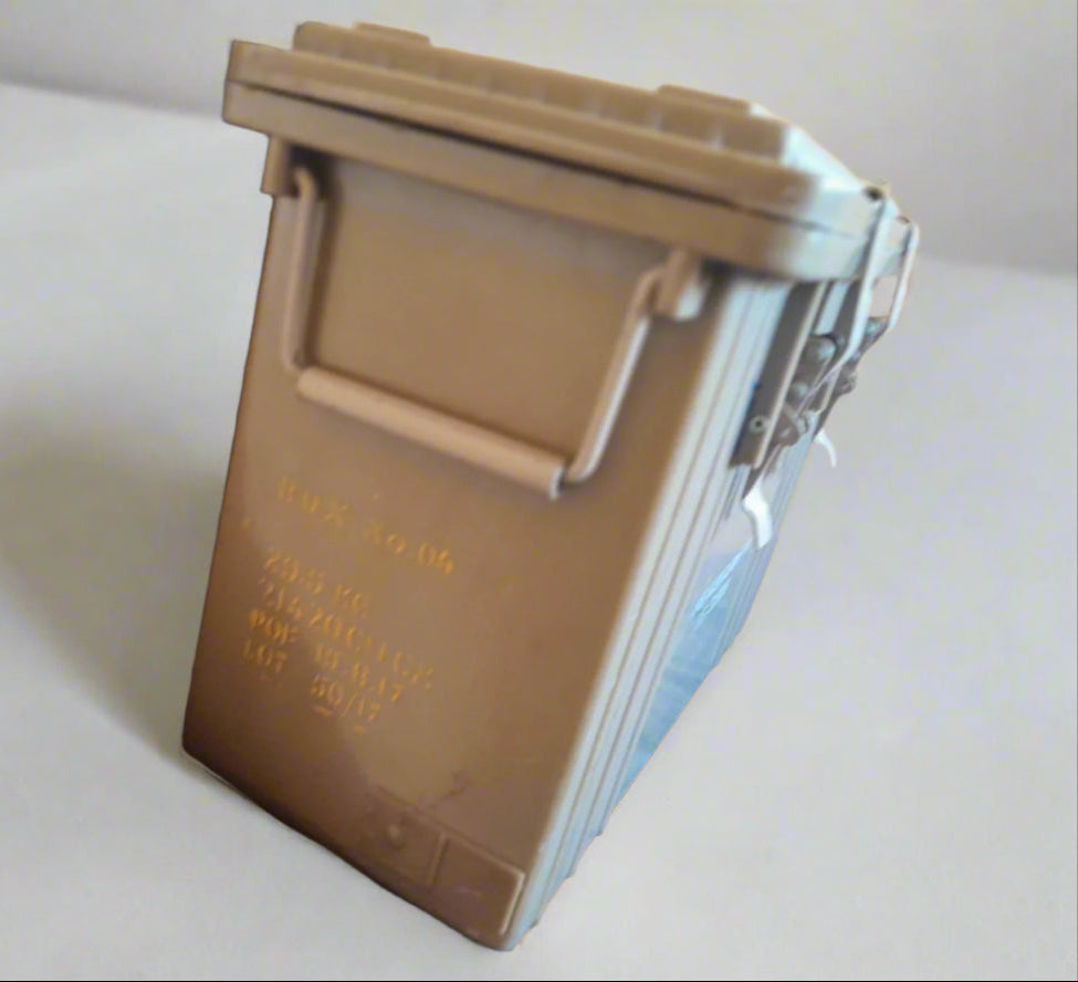 Metallic cylindrical container with a handle on a white background