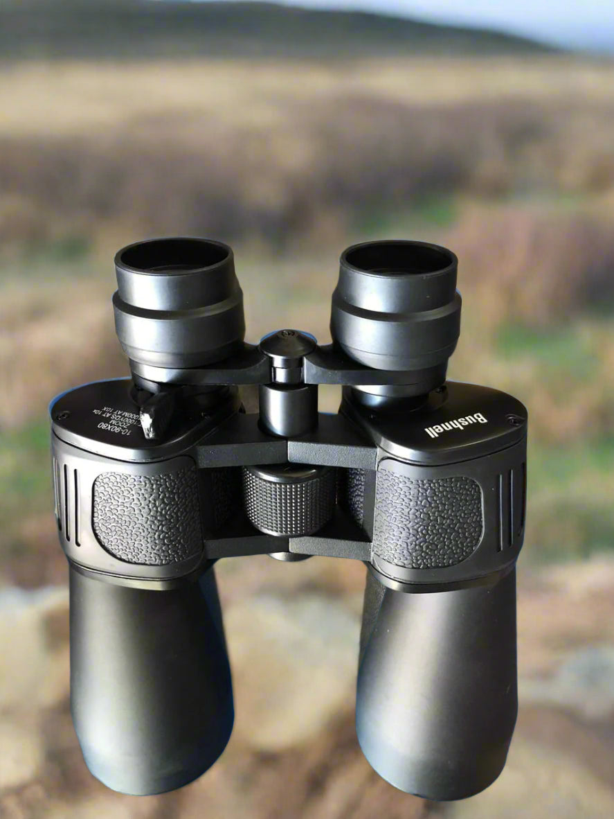 Binoculars with a blurred natural landscape background