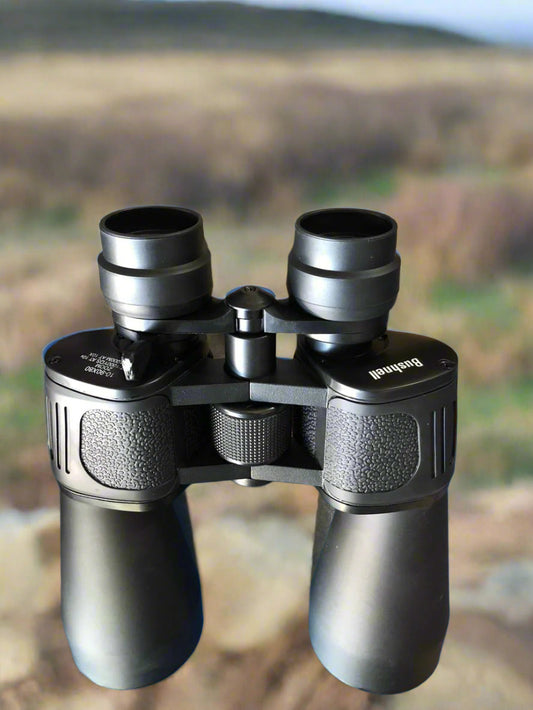 Binoculars with a blurred natural landscape background