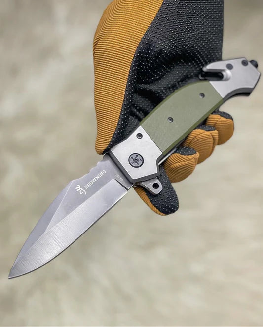 Folding knife with a green handle and brown accents on a neutral background