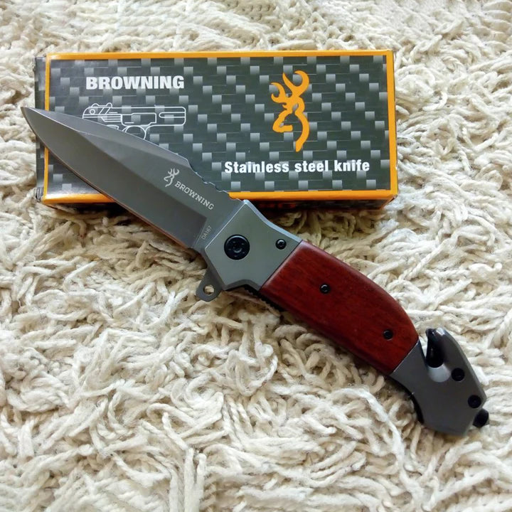 Browning stainless steel knife with red handle on a textured surface