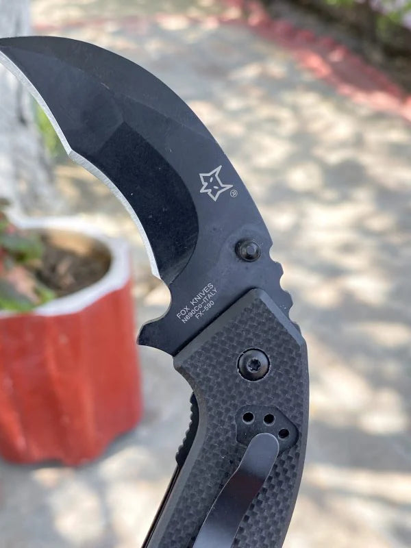 Compact folding tool by Fox in black for outdoor activities and camping