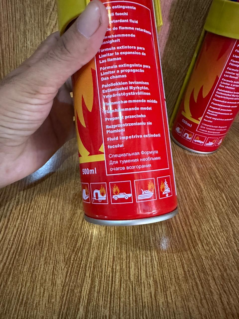 500ml Fire Stop Spray portable fire extinguisher secured in a bright yellow plastic mounting bracket