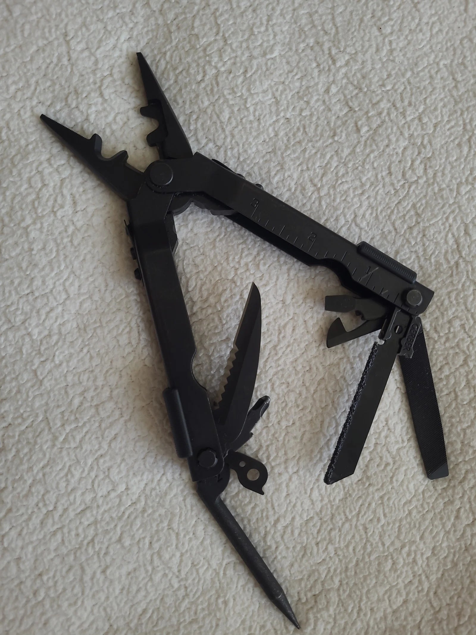 Gerber Multi-Plier 600, multi-tool pliers, portable multitool, camping multitool, survival multitool, outdoor multitool, DIY tool, multi-tool with pliers, professional multitool, black Gerber multitool, stainless steel multitool
