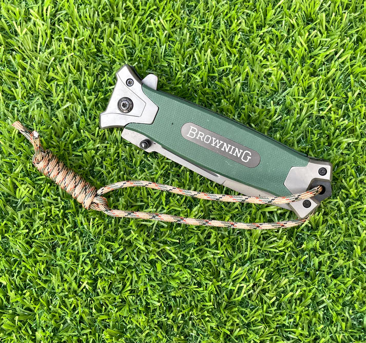 Green Browning 364 survival tool with ergonomic grip for wilderness use
