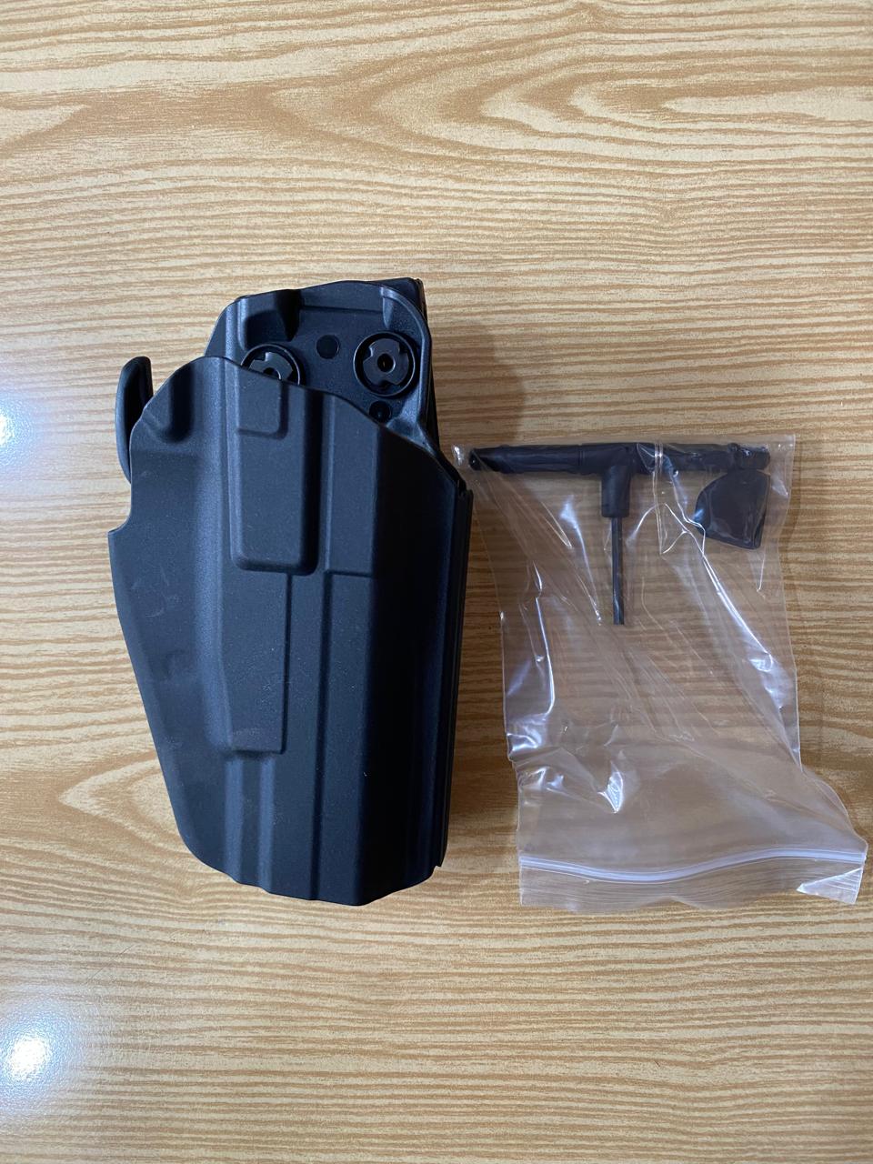 Black holster and plastic bag 