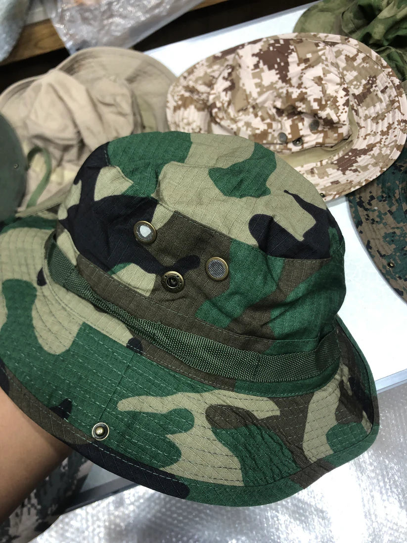 Camouflage bucket hat with visible buttons on a white surface