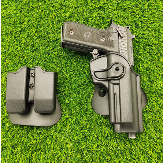 Pistol and holster on a grassy background