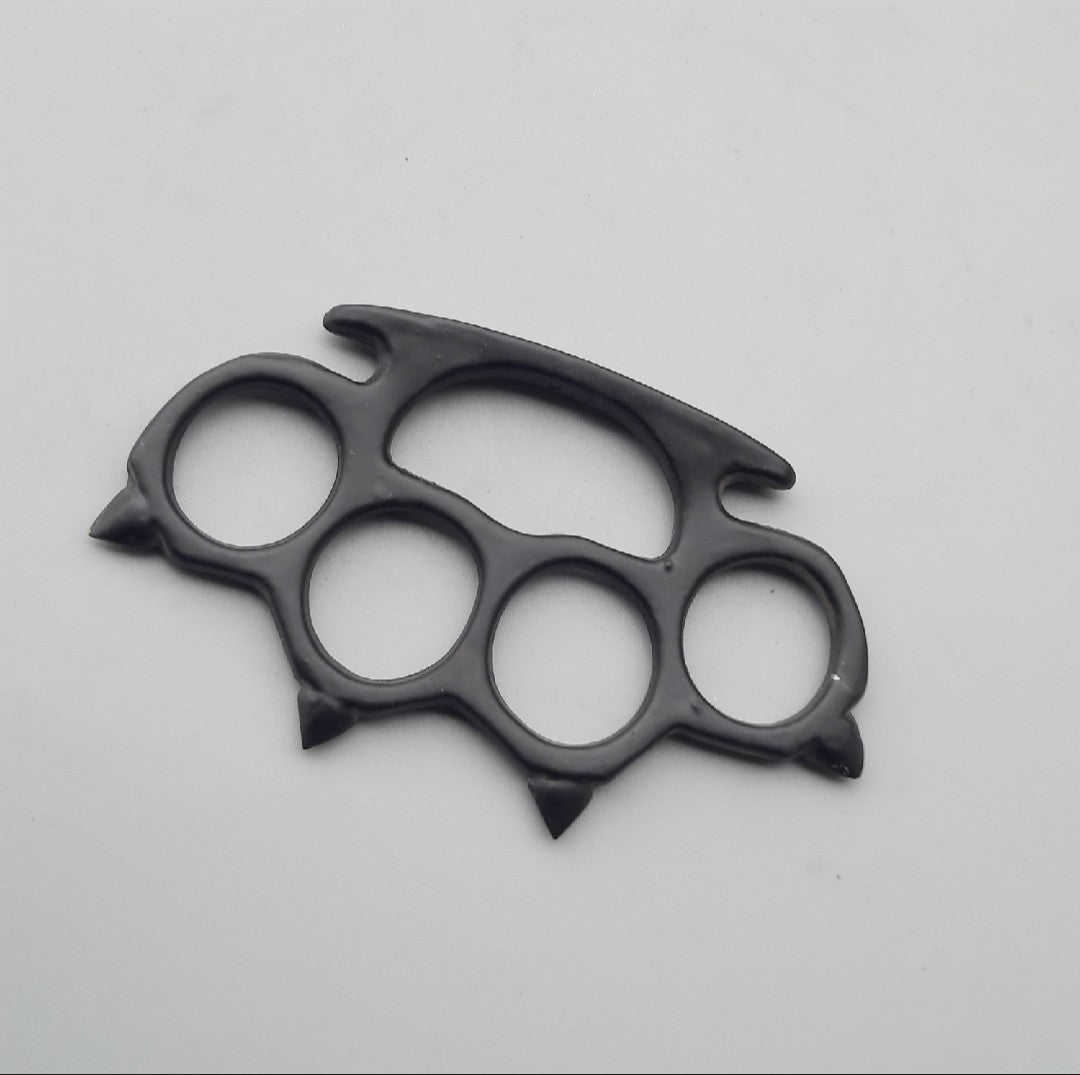 Black brass knuckles on a light gray background