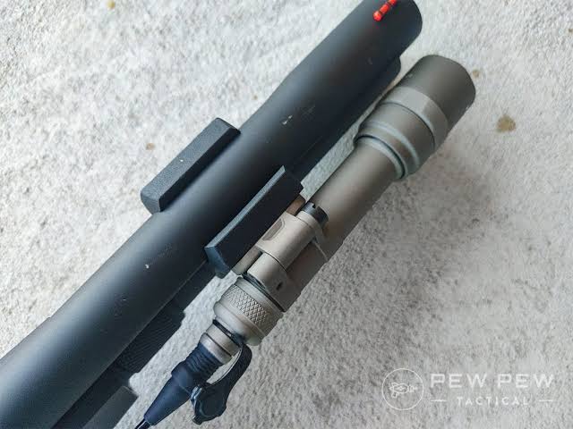 Close-up of a rifle with a Light attached